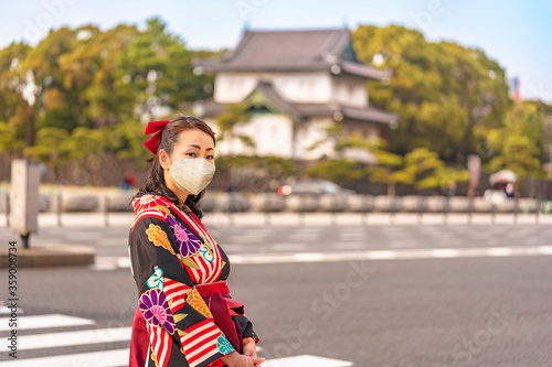 Canvas Print Japanese woman in hakama kimono in front of the dungeon Edojō sakurada tatsumiyagura with moats lined with pine trees outside of the Tokyo Imperial Palace