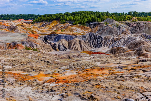 autumn landscape of the space valley with craters and rivers, against a blue sky with clouds and reflections