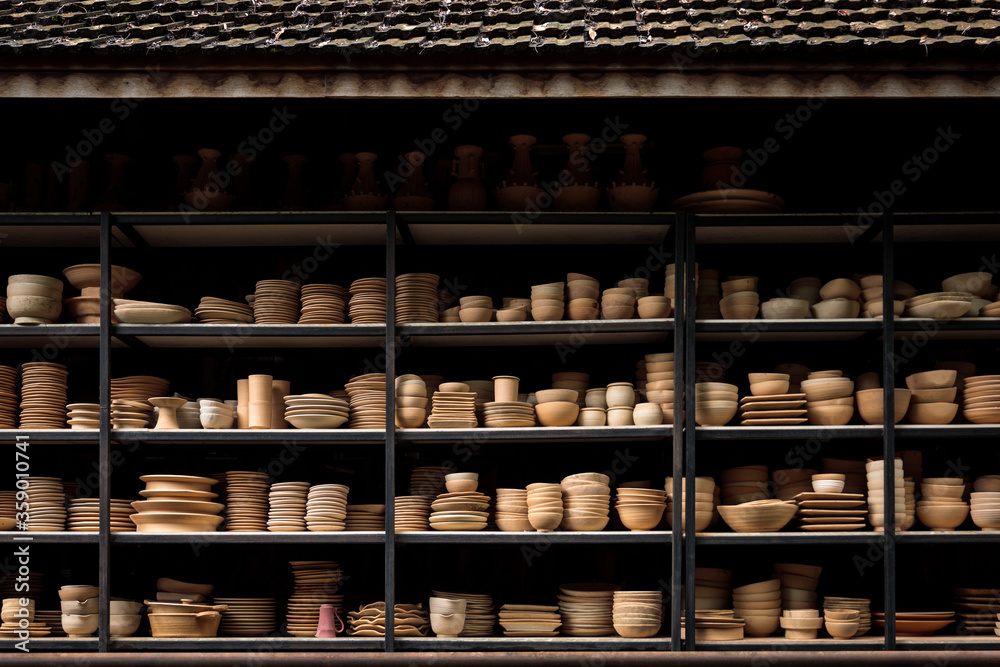 Handcraft ceramic kitchenwares molded arranged on shelve