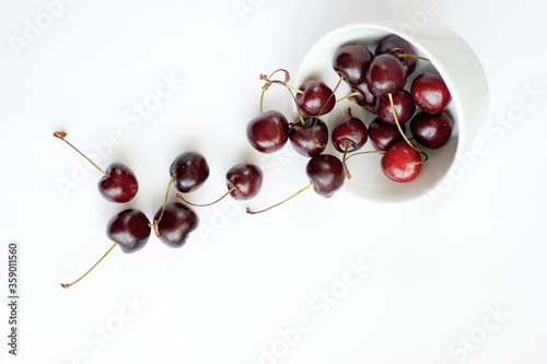 Cherry scattered from the sauce on a white background