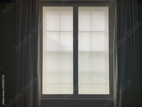 Open window with white curtains 