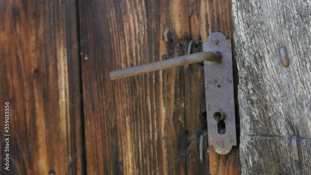 Male tries to open ancient wooden doors 4K video Male tries to open ancient wooden doors 4K video