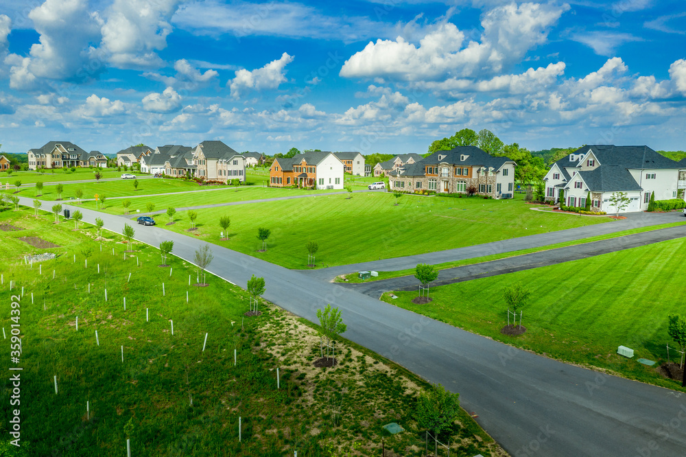 Large estate home villas with acre lot home sites at a new development residential neighborhood in Dayton Maryland USA with cloudy blue sky Large estate home villas with acre lot home sites at a new development residential neighborhood in Dayton Maryland USA with cloudy blue sky