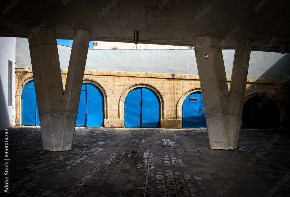 Blue garages under the bridge at the port of the capital of the island of Malta