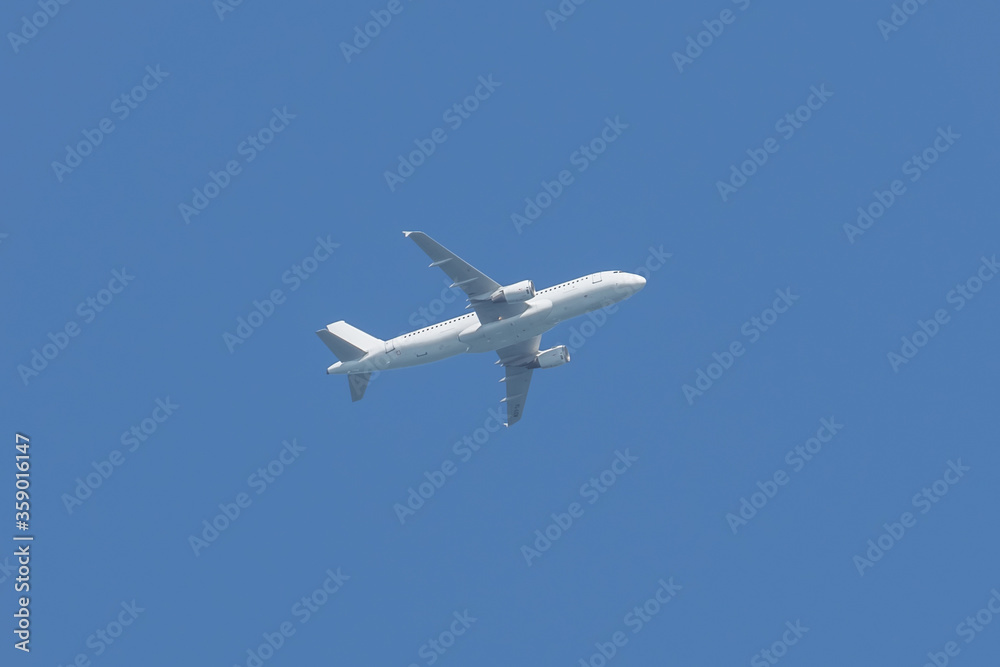 Airplane flying in the sky. Commercial passenger jet airliner in flight after take off from the airport. Bright blue sky background. Transportation and business travel tourism concept. Airplane flying in the sky. Commercial passenger jet airliner in flight after take off from the airport. Bright blue sky background. Transportation and business travel tourism concept.