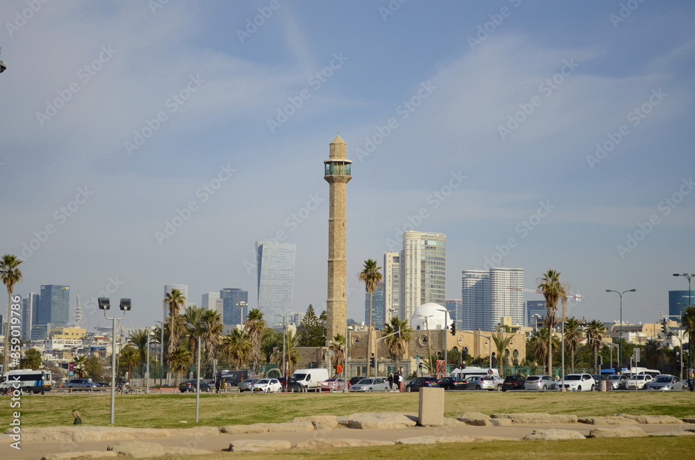 Hassan Bek Mosque. Tel Aviv. Israel. Tower of a mosque in a modern city among skyscrapers and palm trees. Tel Aviv Embankment Hassan Bek Mosque. Tel Aviv. Israel. Tower of a mosque in a modern city among skyscrapers and palm trees. Tel Aviv Embankment