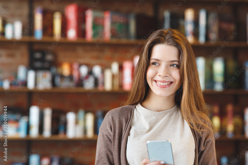 Positive girl blogger with cell phone in hands dreaming Positive girl blogger with cell phone in hands dreaming