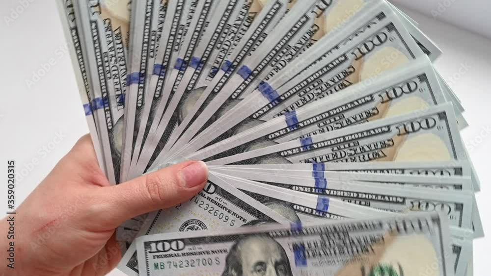 Man hand counting us dollars with nominal of 100, slow motion close up Man hand counting us dollars with nominal of 100, slow motion close up