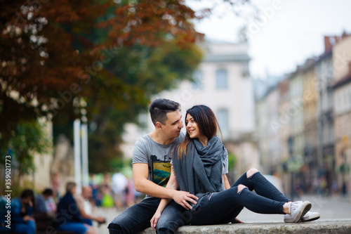 couple posing on the streets of a European city in summer weather.