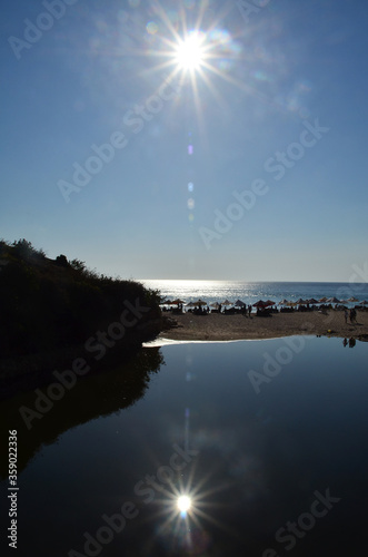 Sun reflection on the beach. Geger Beach is located in Sawangan, about 3 kilometers from the southern area of Nusa Dua.  photo