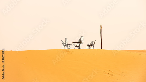 Chairs and table in the sand of the desert