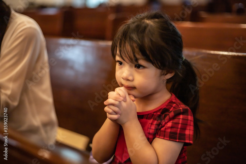 Asian little girl hand praying for faith  spirituality and religion.