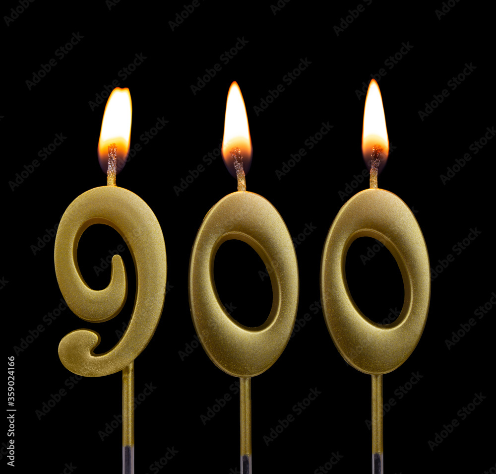 Golden birthday candle isolated on black background, number 900 Golden birthday candle isolated on black background, number 900