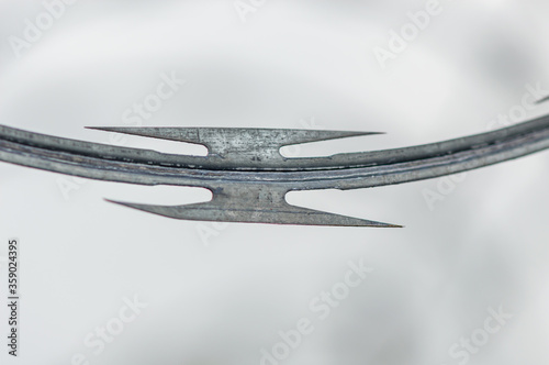 Razor concertina wire against white sky