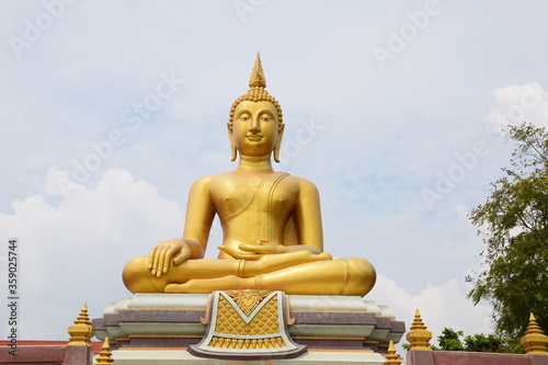 The golden statue of the buddha statue in the sky background