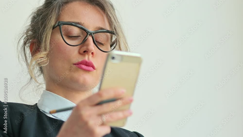 Business lady wearing glasses at office working with papers, tablet and mobile phone Business lady wearing glasses at office working with papers, tablet and mobile phone