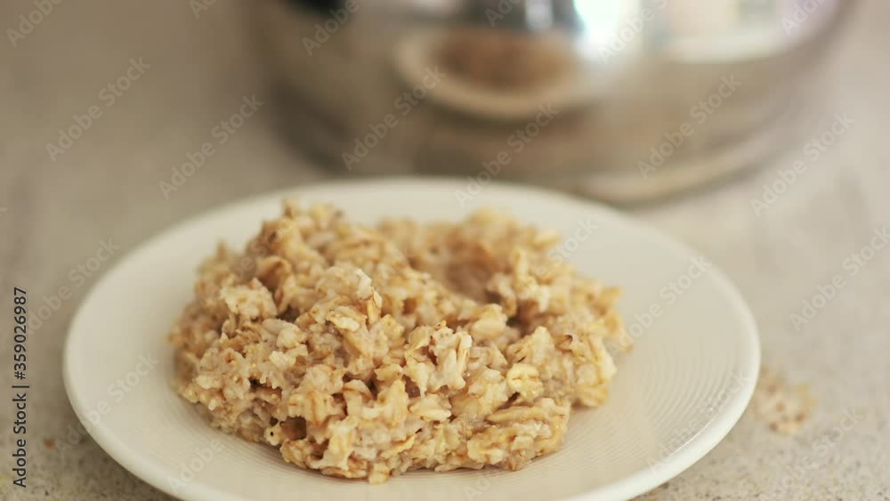 Oat porridge on white plate with foam, close up Oat porridge on white plate with foam, close up
