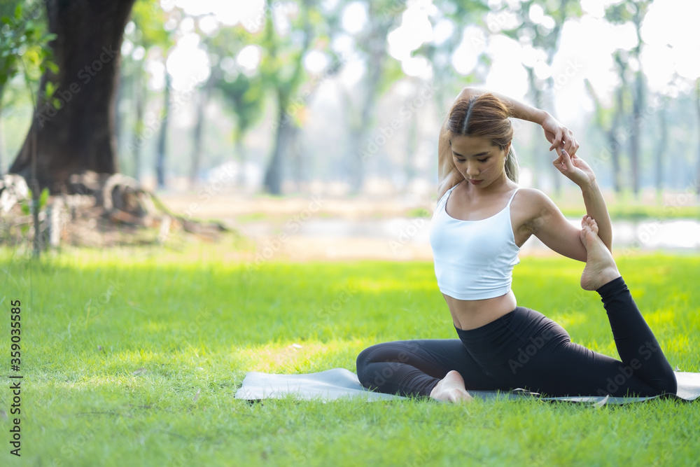 Portrait of young woman practicing yoga in garden.female happiness. blurred background.Healthy lifestyle and relaxation concept.Young Asian Girl doing yoga in the park. Portrait of young woman practicing yoga in garden.female happiness. blurred background.Healthy lifestyle and relaxation concept.Young Asian Girl doing yoga in the park.