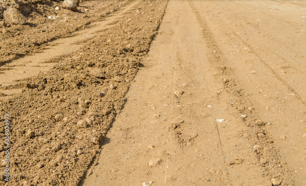Compacted laterite road.Compact red earth.Compact soil in road construction site.