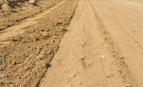 Compacted laterite road.Compact red earth.Compact soil in road construction site.