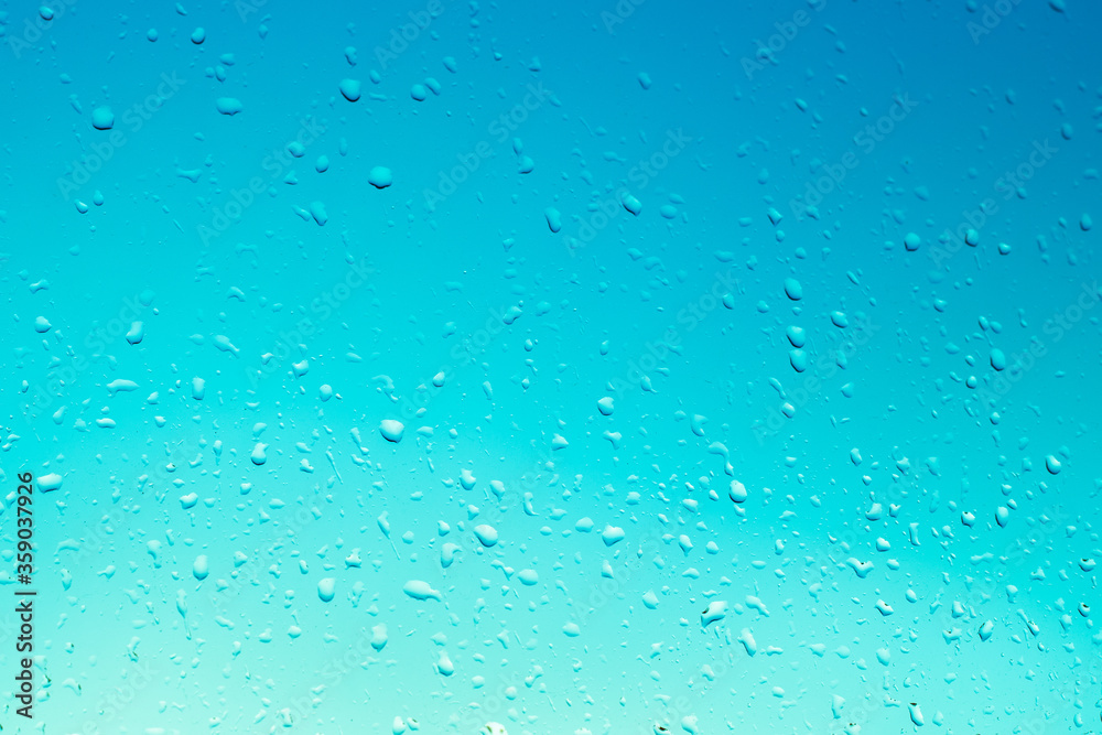 blue window glass background with raindrops, light gradient, texture