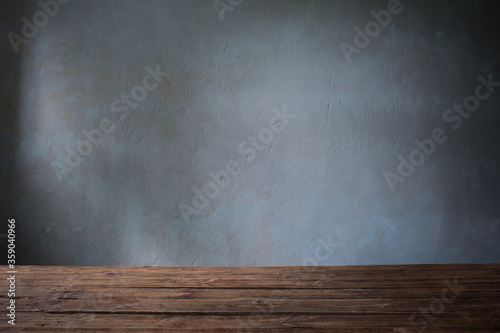 old wooden table on background dark wall