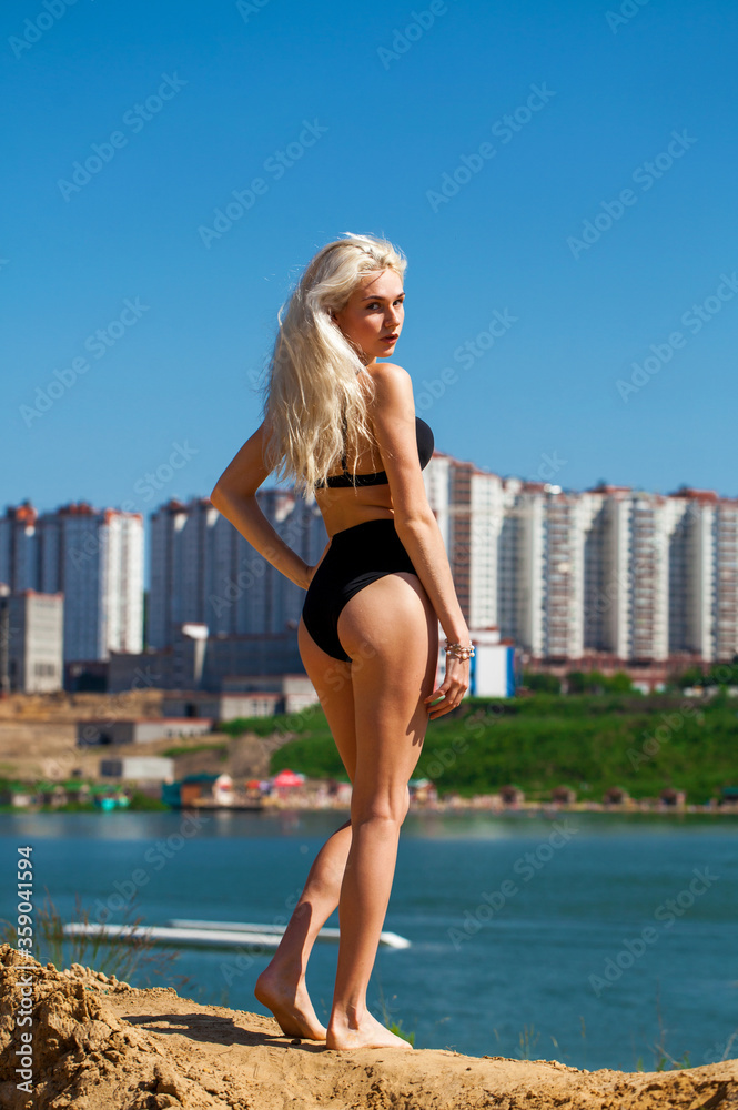 Full body portrait of a young beautiful woman in black bikini Full body portrait of a young beautiful woman in black bikini