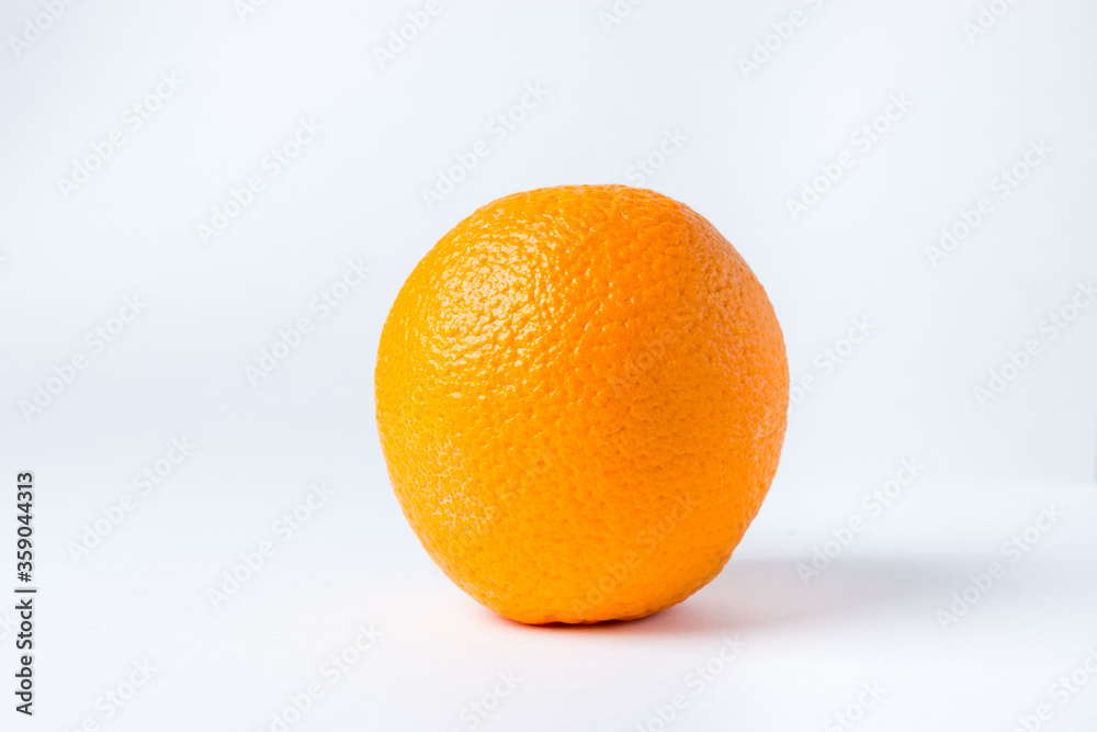 One orange on a white background. A whole orange in a peel. One orange on a white background. A whole orange in a peel.