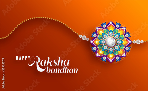Decorated rakhi for Indian festival Raksha Bandhan Greeting Card ,indian festival with gold patterned and crystals on paper color Background.