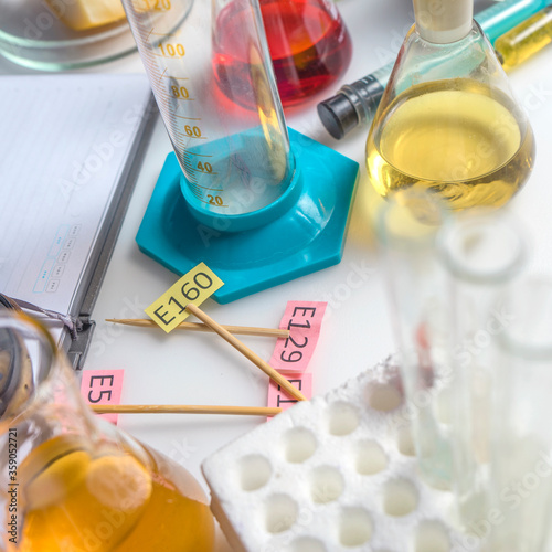 Laboratory assistant's desk. Additive E tablets, test tubes and instruments close-up. Food laboratory.