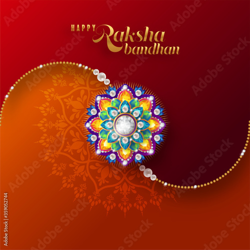 Decorated rakhi for Indian festival Raksha Bandhan Greeting Card ,indian festival with gold patterned and crystals on paper color Background.