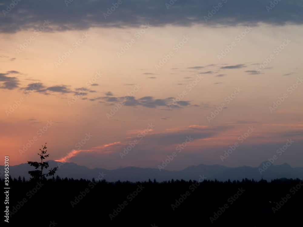 Silhouette of Northwest Cascade Range and forest during twilight hours on Mercer Island on a spring day.