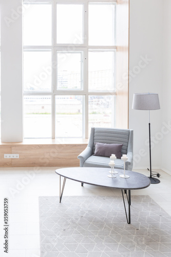 Luxury fashionable modern design studio apartment with a free layout in a minimal style. very bright huge spacious room with white walls and wooden elements. sitting area with fireplace © 4595886