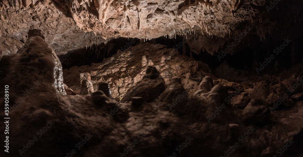 Inside the mysterious flowstone cave 'Nebelhöhle' with stalagmites and stalactites in Germany.