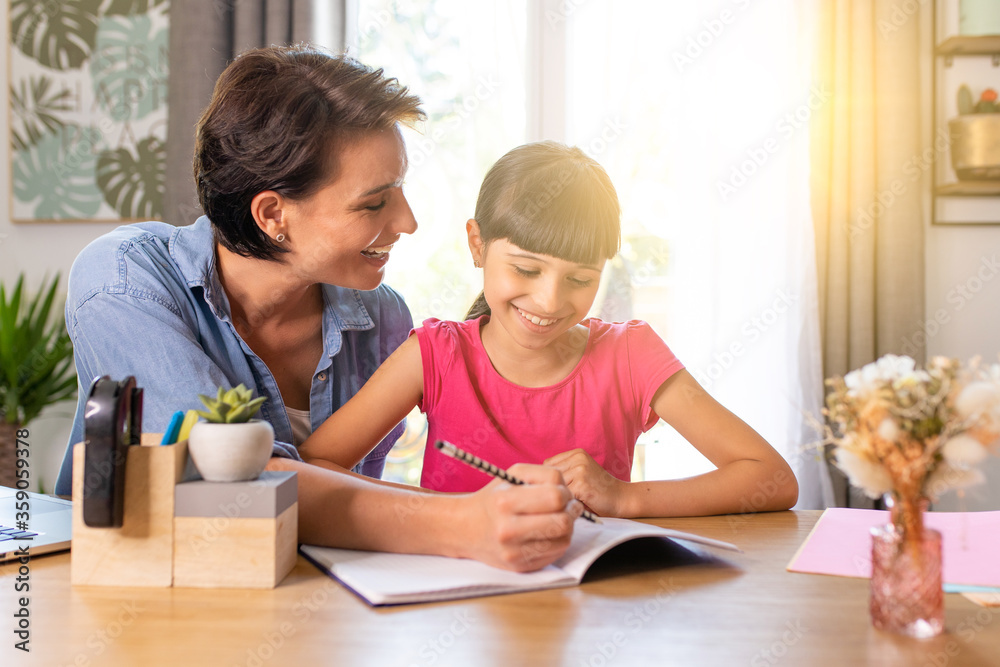 a mother and daughter doing homework at home in a good mood a mother and daughter doing homework at home in a good mood