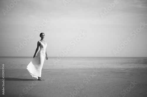 Young lady jumping on the beach