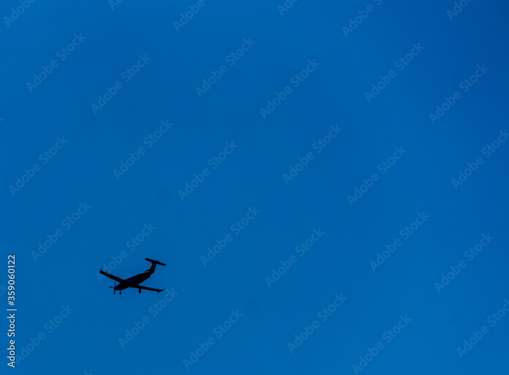 Plane flying to no where in bright blue sky with no clouds background great for text photograph Plane flying to no where in bright blue sky with no clouds background great for text photograph