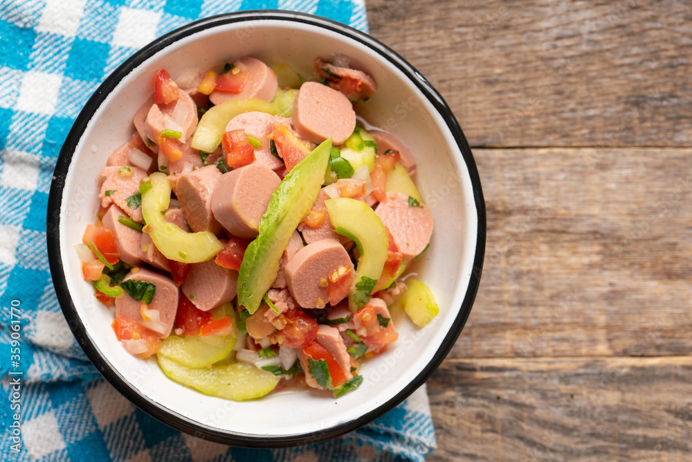 Mexican sausage ceviche with avocado on wooden background Mexican sausage ceviche with avocado on wooden background