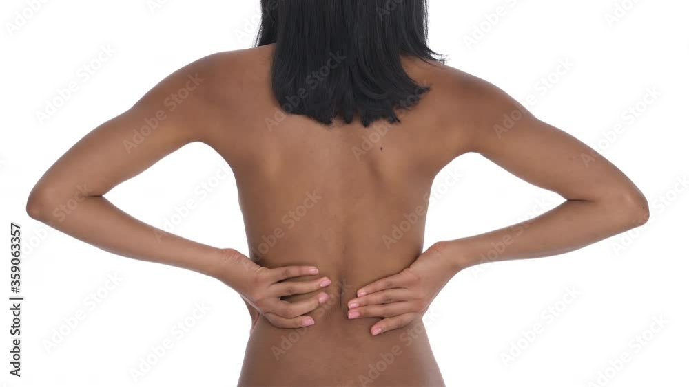 Back view of a black woman having kidney pain. Massaging her back with both hands. Healthcare concept. Isolated one the white background. Back view of a black woman having kidney pain. Massaging her back with both hands. Healthcare concept. Isolated one the white background.