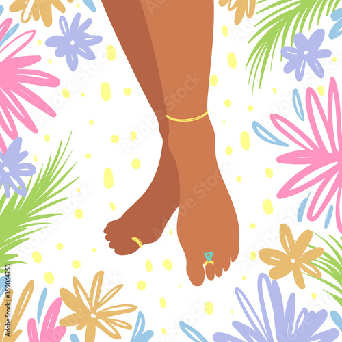 Black african american female foots with golden jewelry surrounded with tropical flowers