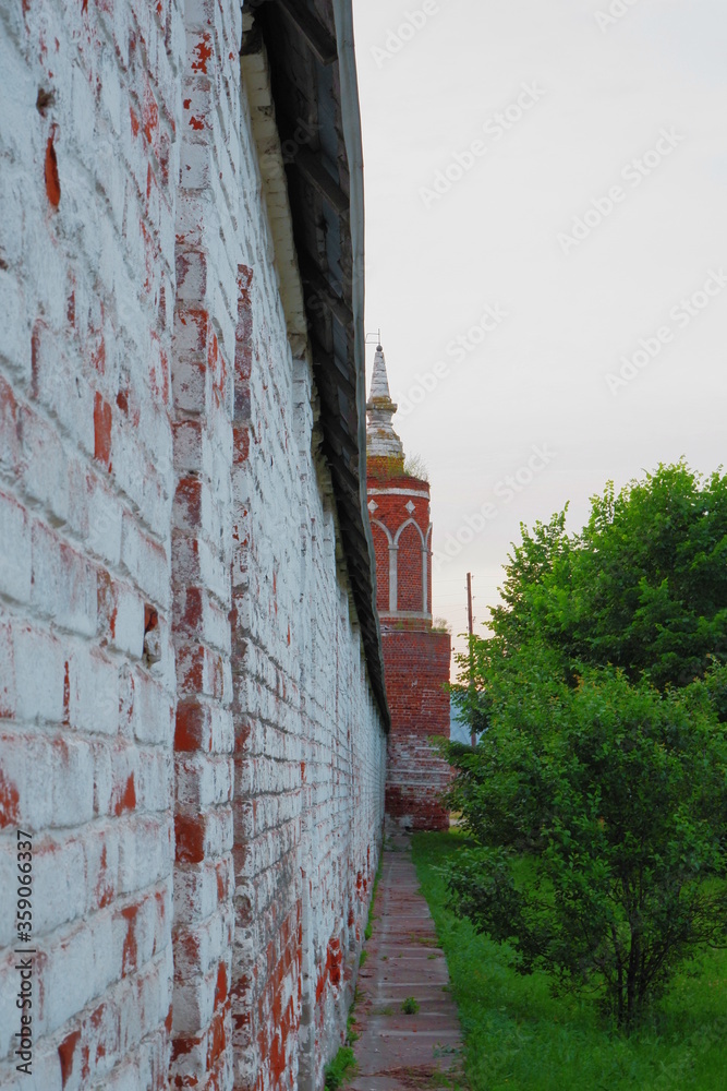 brick wall with an old tower