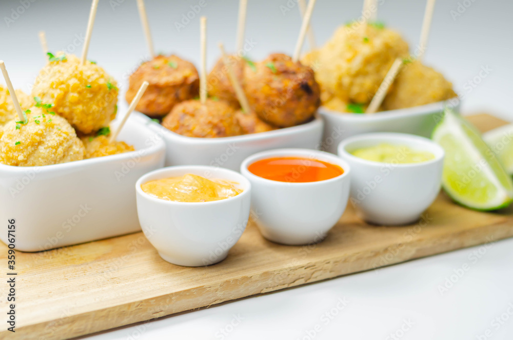 Various mini chicken kievs and sweet potato falafels served with sauces