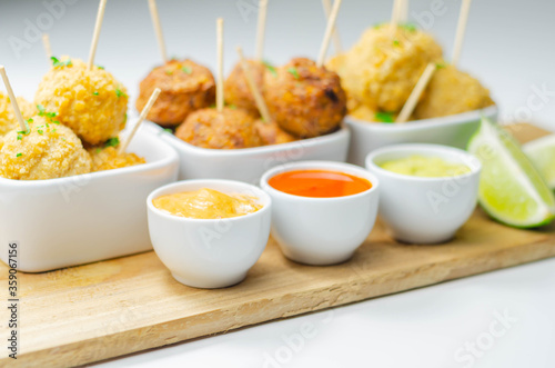 Various mini chicken kievs and sweet potato falafels served with sauces