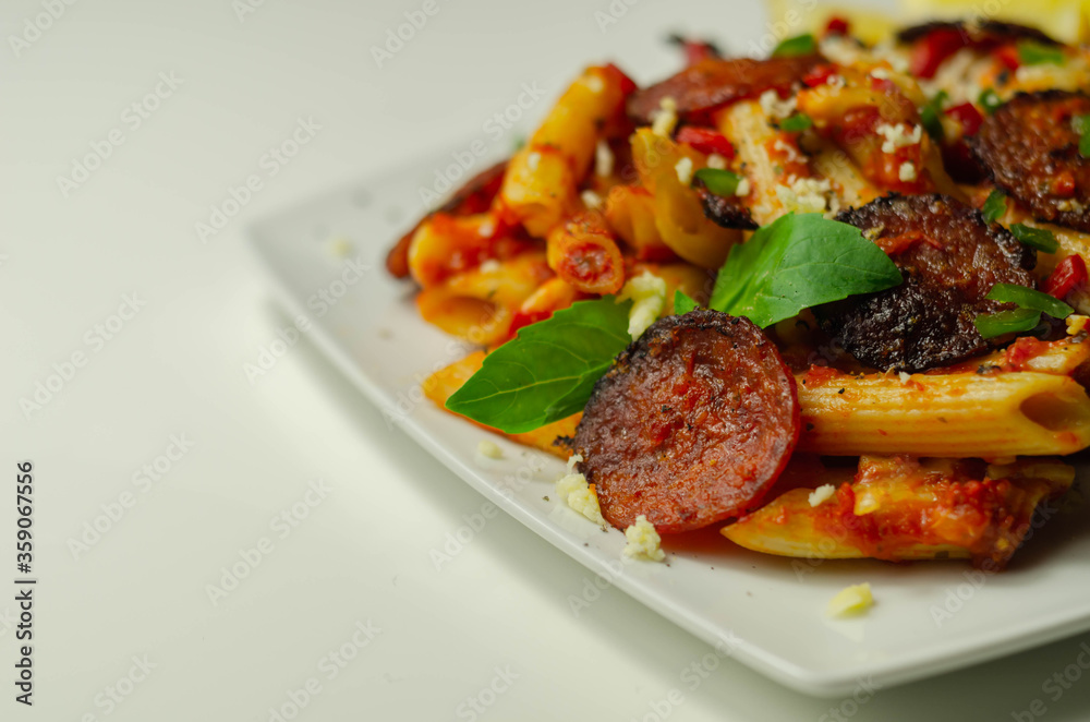Pennette pasta in a spicy tomato sauce with sliced pepperoni, mozzarella, and mature cheddar cheeses Pennette pasta in a spicy tomato sauce with sliced pepperoni, mozzarella, and mature cheddar cheeses