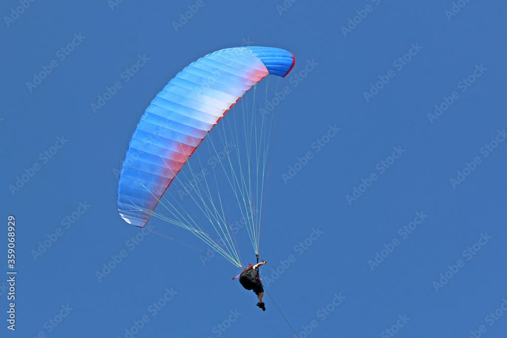 Paraglider flying wing in a blue sky	