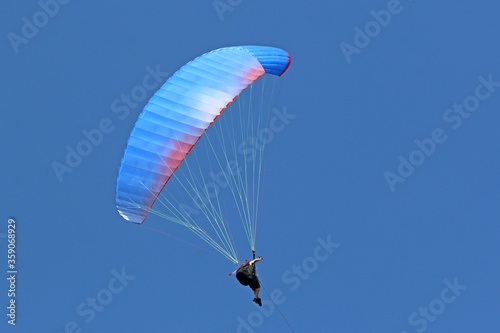 Paraglider flying wing in a blue sky 