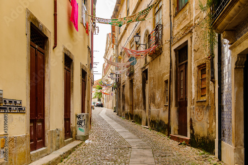 Fototapeta Naklejka Na Ścianę i Meble -  Narrow street of the Historic center of Coimbra, Portugal. World Heritage site by UNESCO since 2013