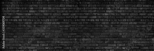 Background Of Old Vintage Dirty Dark Black Brick Wall With Peeling Plaster. Shabby Building Facade. Long Panoramic Banner.