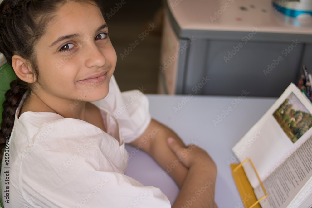 Little beautiful girl in a white dress is reading a book. Good for billboards, posters, flyers. Little beautiful girl in a white dress is reading a book. Good for billboards, posters, flyers.