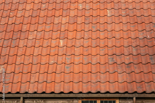 Old red tile roof fragment. Background image.